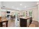 Kitchen island overlooking the living room with a fireplace and lots of windows at 106 Logan Pass Dr, Loganville, GA 30052