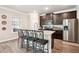 Modern kitchen featuring granite countertops, stainless steel appliances, and a convenient breakfast bar at 106 Logan Pass Dr, Loganville, GA 30052