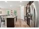 Kitchen with granite counters, stainless steel appliances, and an eat-in island at 106 Logan Pass Dr, Loganville, GA 30052