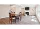 Open-concept living room with coffered ceilings, fireplace, and wood-look floors at 106 Logan Pass Dr, Loganville, GA 30052
