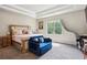 Main bedroom featuring a bed, seating area, and a large window at 106 Logan Pass Dr, Loganville, GA 30052