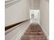 Carpeted staircase leading to the upper level of the home at 106 Logan Pass Dr, Loganville, GA 30052