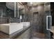 Modern bathroom with double vanity sinks, stylish tile shower, and glass door at 175 15Th Ne St # 410, Atlanta, GA 30309