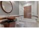 Bathroom featuring decorative sink, marble tile, and glass shower with copper accent at 175 15Th Ne St # 410, Atlanta, GA 30309