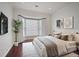 Bedroom featuring hardwood floors, white walls, large windows, and stylish decor at 175 15Th Ne St # 410, Atlanta, GA 30309