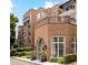 Brick building featuring elegant windows, wrought iron balconies, and manicured landscaping around the property at 175 15Th Ne St # 410, Atlanta, GA 30309
