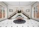 Grand foyer featuring a crystal chandelier, elegant staircase, and decorative tile flooring at 175 15Th Ne St # 410, Atlanta, GA 30309