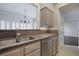 Kitchen with stainless steel dishwasher and sink, granite countertops, and view into living room at 175 15Th Ne St # 410, Atlanta, GA 30309