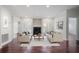 Bright living room with hardwood floors, fireplace, neutral decor, and double doors leading to an outdoor space at 175 15Th Ne St # 410, Atlanta, GA 30309