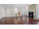 Open-concept living room with hardwood floors, fireplace, and view into kitchen through doorway and dining area at 175 15Th Ne St # 410, Atlanta, GA 30309