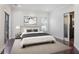 Bright bedroom featuring hardwood floors, large window, and sliding doors to modern bathroom at 175 15Th Ne St # 410, Atlanta, GA 30309