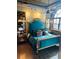 Bright bedroom with a teal bed frame, elegant gold accents, and large windows overlooking a city view at 3180 Mathieson Drive # 502, Atlanta, GA 30305