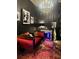 Elegant bedroom featuring a red velvet chaise lounge, ornate chandelier, and dark wallpaper at 3180 Mathieson Drive # 502, Atlanta, GA 30305