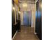 Hallway with wooden floors, decorative mirror, and stylish lighting at 3180 Mathieson Drive # 502, Atlanta, GA 30305