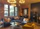 A stylish living room features exposed brick, a large blue sofa, and modern light fixtures at 3180 Mathieson Drive # 502, Atlanta, GA 30305