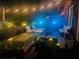 Evening shot of the cozy backyard patio features ample seating, patio lights, and lush landscaping at 3180 Mathieson Drive # 502, Atlanta, GA 30305