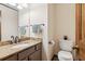 Bathroom featuring granite countertop vanity, dark fixtures and adjacent toilet at 6165 Pin Oak Ln, Alpharetta, GA 30005