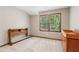 Neutral-toned bedroom featuring a window view and wooden furniture at 6165 Pin Oak Ln, Alpharetta, GA 30005
