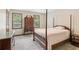 Carpeted bedroom with two windows and classic wooden furniture at 6165 Pin Oak Ln, Alpharetta, GA 30005
