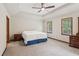 Spacious bedroom boasts tray ceilings, ceiling fan and sunny windows at 6165 Pin Oak Ln, Alpharetta, GA 30005