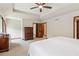 Bright bedroom featuring tray ceilings, neutral walls, and closet access at 6165 Pin Oak Ln, Alpharetta, GA 30005