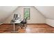 Charming bedroom featuring hardwood floors, a large window, and sloped ceiling at 6165 Pin Oak Ln, Alpharetta, GA 30005
