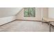 Spacious bedroom features a carpeted floor, large window, and sloped ceiling at 6165 Pin Oak Ln, Alpharetta, GA 30005