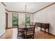 Bright dining room with hardwood floors, and large windows at 6165 Pin Oak Ln, Alpharetta, GA 30005