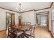 Elegant dining room with hardwood floors and a classic chandelier at 6165 Pin Oak Ln, Alpharetta, GA 30005