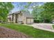 Beautiful two-story home with well-maintained lawn and three car garage at 6165 Pin Oak Ln, Alpharetta, GA 30005
