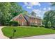 Charming brick home featuring a beautifully manicured lawn and classic architectural details at 6165 Pin Oak Ln, Alpharetta, GA 30005