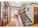 Open foyer with hardwood floors, staircase, and views into the dining room at 6165 Pin Oak Ln, Alpharetta, GA 30005