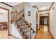 Welcoming foyer showcasing hardwood floors, a carpeted staircase, and classic wood trim at 6165 Pin Oak Ln, Alpharetta, GA 30005