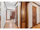 Well-lit hallway with hardwood flooring and classic wood trim accents throughout at 6165 Pin Oak Ln, Alpharetta, GA 30005