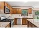 Updated kitchen with stainless steel appliances and a tile backsplash at 6165 Pin Oak Ln, Alpharetta, GA 30005