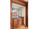A cozy wet bar with dark cabinetry, a small sink, and shelving for glassware at 6165 Pin Oak Ln, Alpharetta, GA 30005