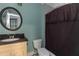 Cozy bathroom featuring a vanity, toilet, and tub with dark brown shower curtain at 1786 Dekalb Ne Ave, Atlanta, GA 30307