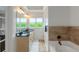 Bright bathroom with a double vanity and tub under bright windows at 1786 Dekalb Ne Ave, Atlanta, GA 30307
