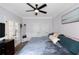 Cozy bedroom featuring a queen-sized bed with plush bedding, modern ceiling fan and closet doors at 1786 Dekalb Ne Ave, Atlanta, GA 30307