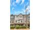 Charming two-story townhome featuring a stone entryway, inviting curb appeal, and a well-maintained landscaped yard at 1786 Dekalb Ne Ave, Atlanta, GA 30307