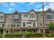 Charming townhome with a stone-accented porch, manicured hedges, and neutral-tone siding at 1786 Dekalb Ne Ave, Atlanta, GA 30307