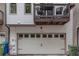View of the two-car garage and an adjacent balcony that has 2 chairs and a table at 1786 Dekalb Ne Ave, Atlanta, GA 30307