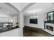 Open living room showcasing dark hardwood floors, a fireplace, and seamless flow into the kitchen at 1786 Dekalb Ne Ave, Atlanta, GA 30307