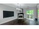 Spacious living area featuring fireplace, access to outdoor deck and seamless flow into dining area at 1786 Dekalb Ne Ave, Atlanta, GA 30307