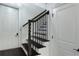 Bright staircase with dark hardwood steps and decorative railing connecting levels with white doors at 1786 Dekalb Ne Ave, Atlanta, GA 30307