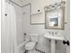 All white bathroom featuring a shower and tub combination, pedestal sink, and checkered floor at 21 Barksdale Ne Dr, Atlanta, GA 30309