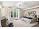 Comfortable bedroom with a tray ceiling, large window, and sitting area at 21 Barksdale Ne Dr, Atlanta, GA 30309