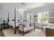 Light-filled bedroom with four poster bed, accent pillows, white shutters and natural light at 21 Barksdale Ne Dr, Atlanta, GA 30309