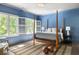 Blue bedroom featuring wooden floors, plantation shutters and a 4 poster bed at 21 Barksdale Ne Dr, Atlanta, GA 30309