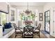 Elegant dining room features a glass table, decorative chairs, and a window seat with custom cushions at 21 Barksdale Ne Dr, Atlanta, GA 30309